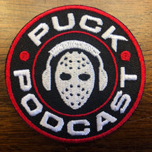 Load image into Gallery viewer, Flex-Fit Hat with the Puck Podcast embroidered twill crest $39 (Black)
