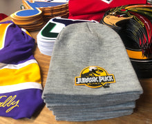Load image into Gallery viewer, Beanie (Grey) with a Jurassic Puck crest / logo $29
